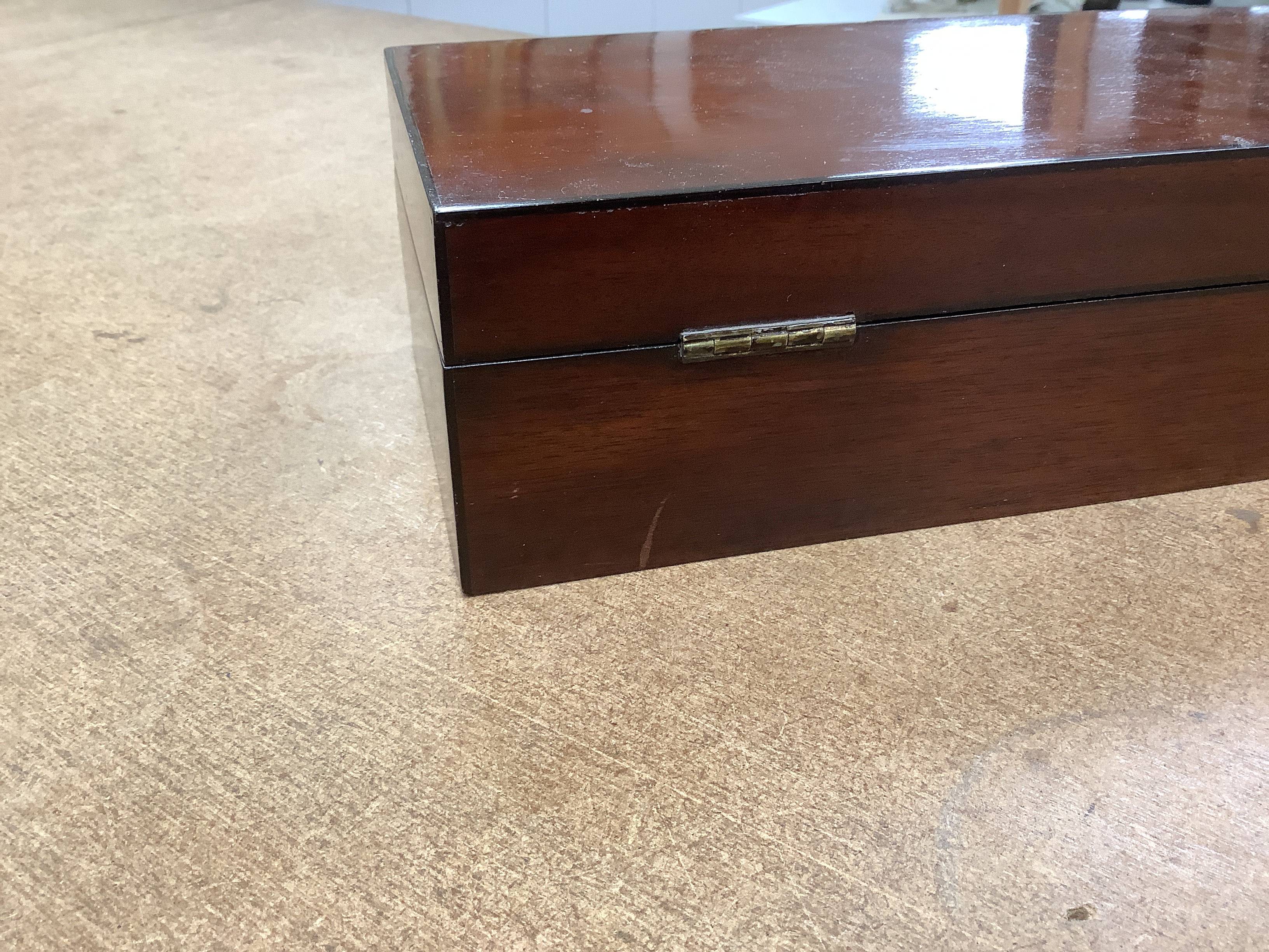 A 19th century mahogany glove box, three pairs of kid leather gloves and a rosewood tea caddy with bone escutcheon, glove box 40cm wide